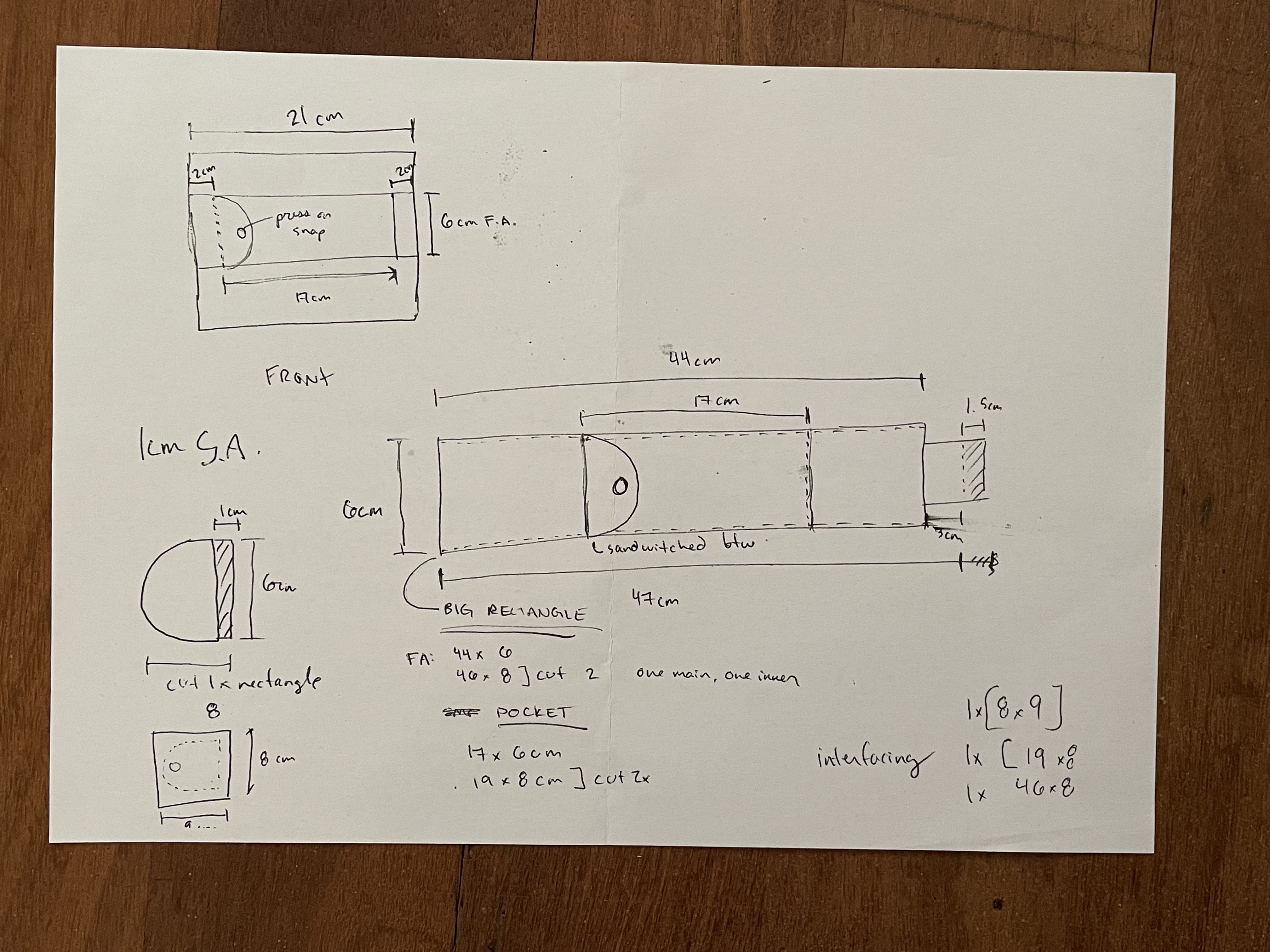 A photo of a sketch showing a draft pattern for a book elastic with pen / pencil holder.